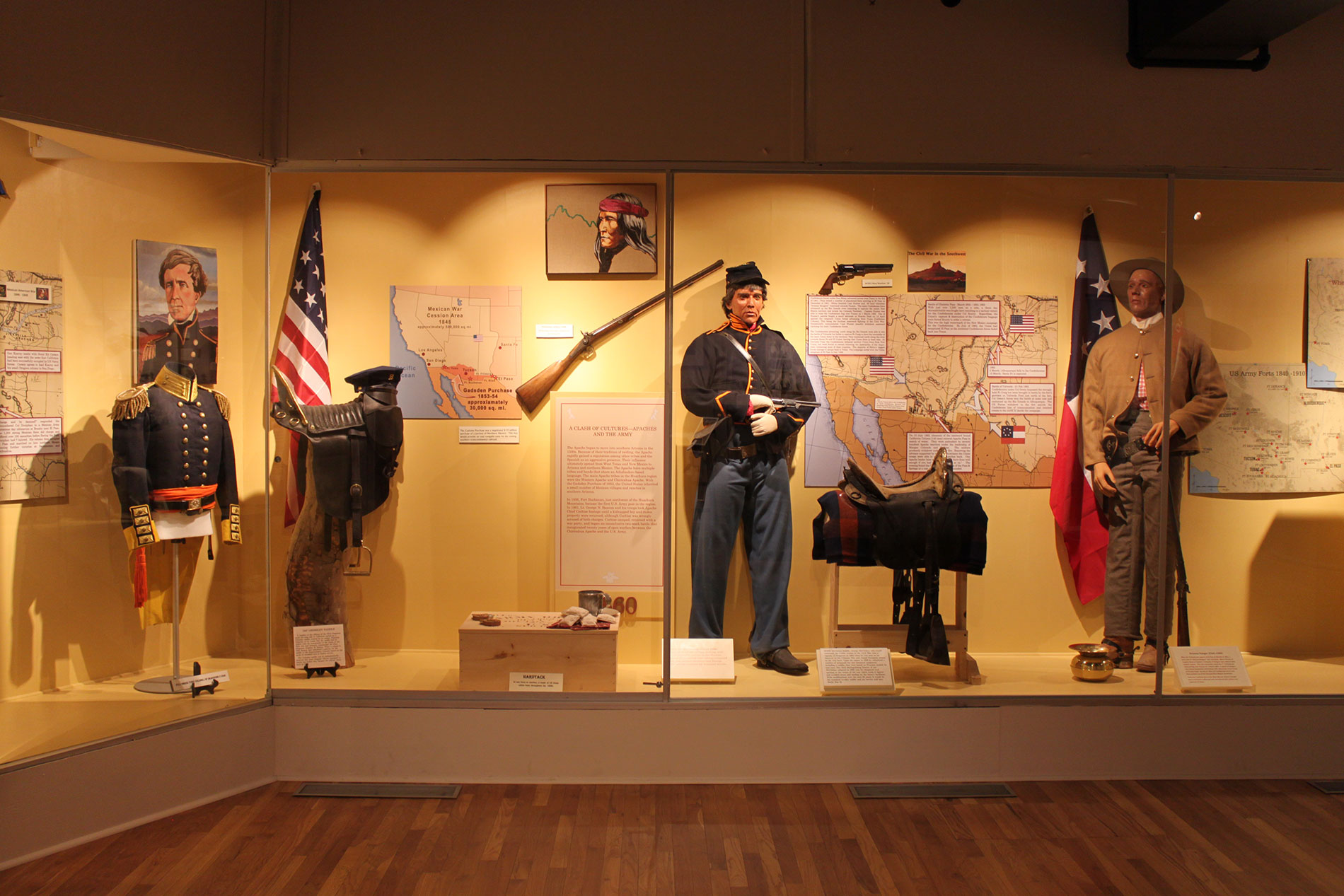 Corner museum display with several artifacts inside glass enclosure_B.